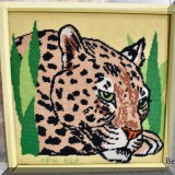 A29. Framed cheetah needlepoint.